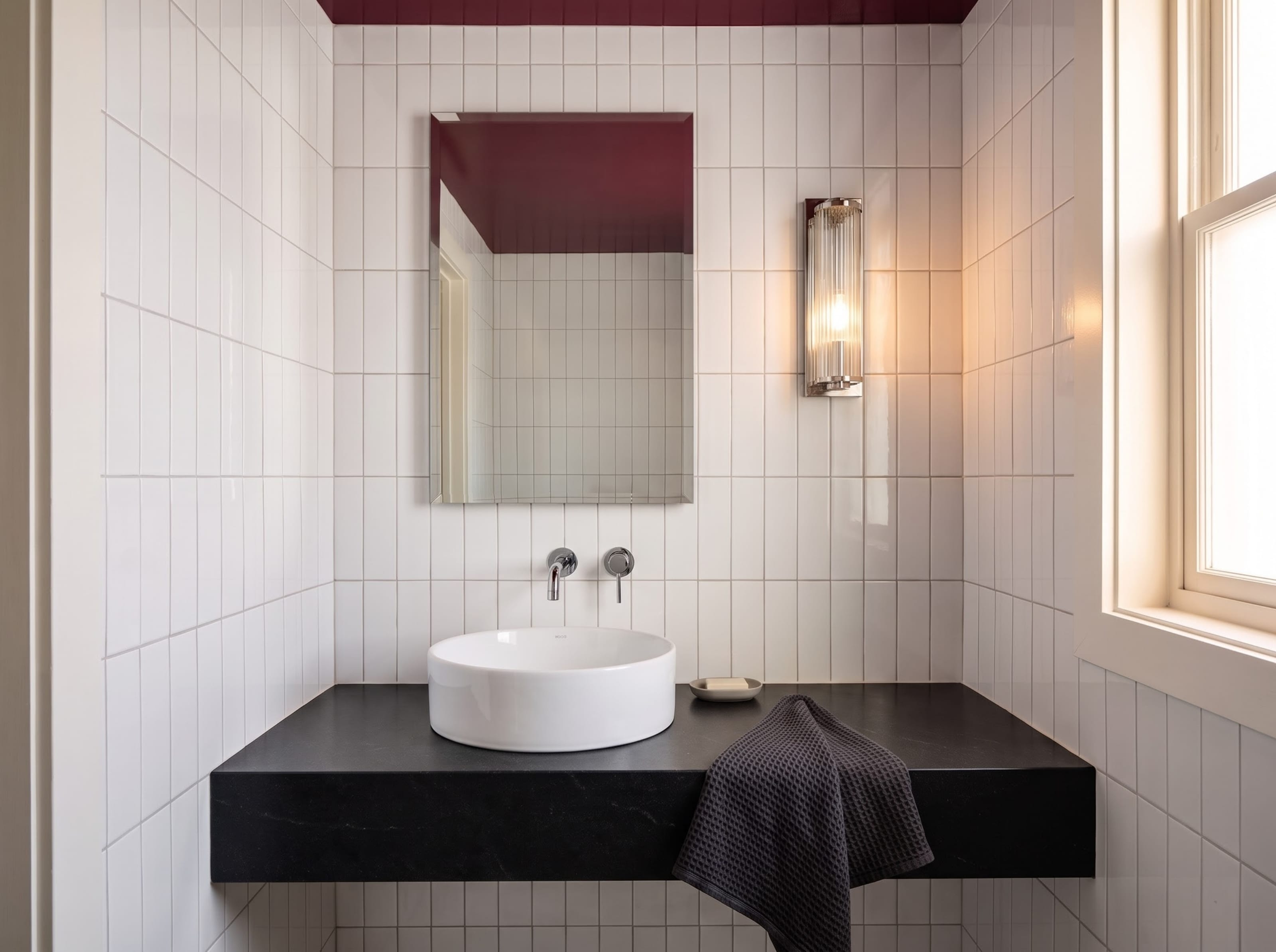 Small powder room design concept with a glossy wine-colored ceiling, pale vertical ceramic tile, and a floating counter with vessel basin.
