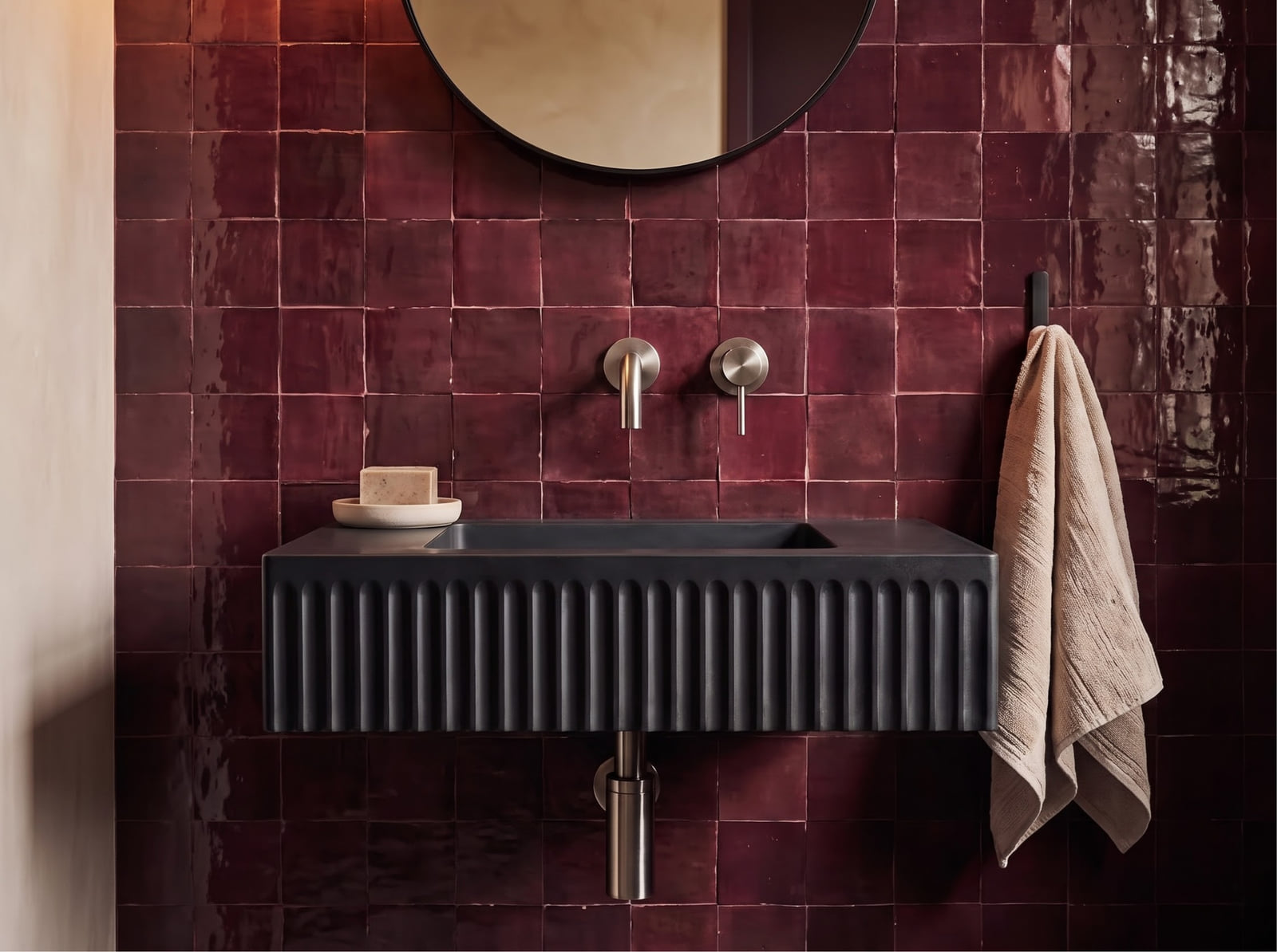 Inline detail view showing single-handle brushed nickel wall faucet aligned over a matte black fluted basin.