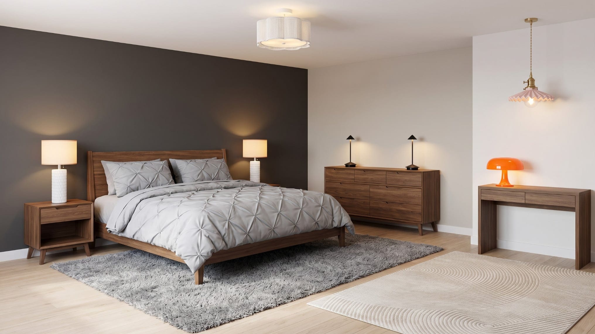 Bedroom with a charcoal accent wall and gray pintuck bed, a walnut dresser with black cordless lamps, a walnut console with an orange mushroom lamp and a pink pendant.