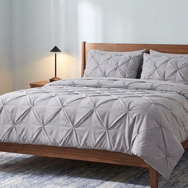 Gray pintuck bedding with a black lamp