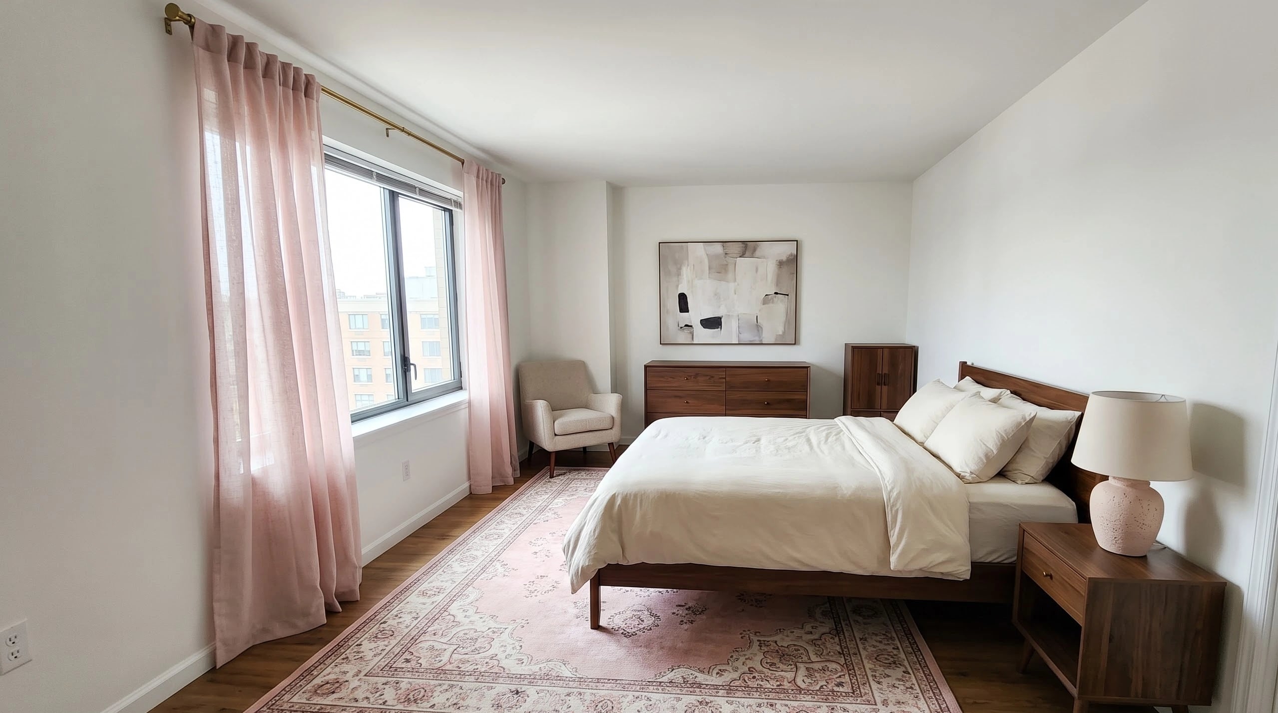 Contemporary bedroom with an expansive low-pile rose patterned area rug grounding a bed and clean architectural walls