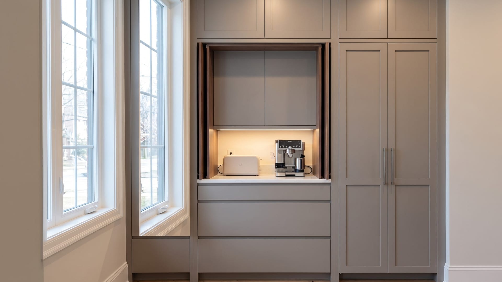 Wide appliance-garage cabinet wall with an illuminated appliance niche