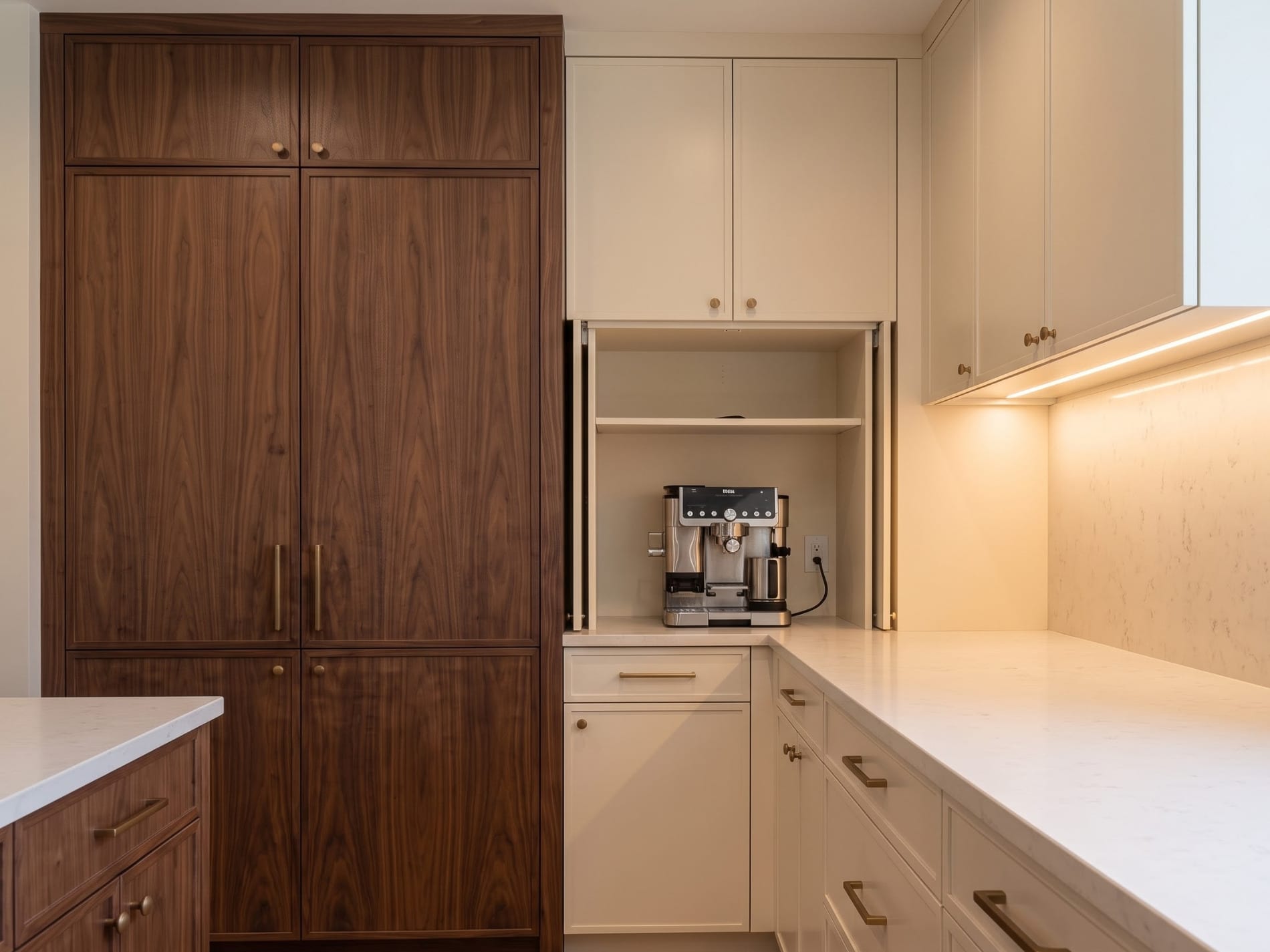 Dedicated coffee niche integrated into tall walnut pantry cabinetry