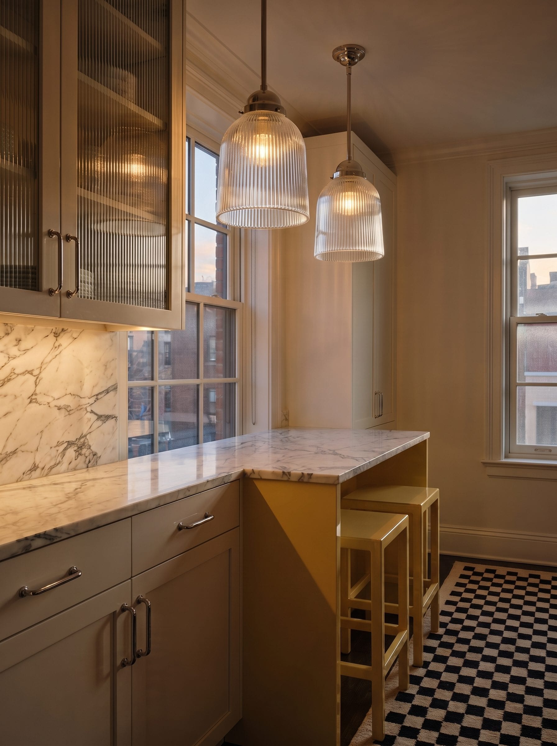 A butter-yellow kitchen alcove shifting from bright morning sun to glowing night-time lighting.