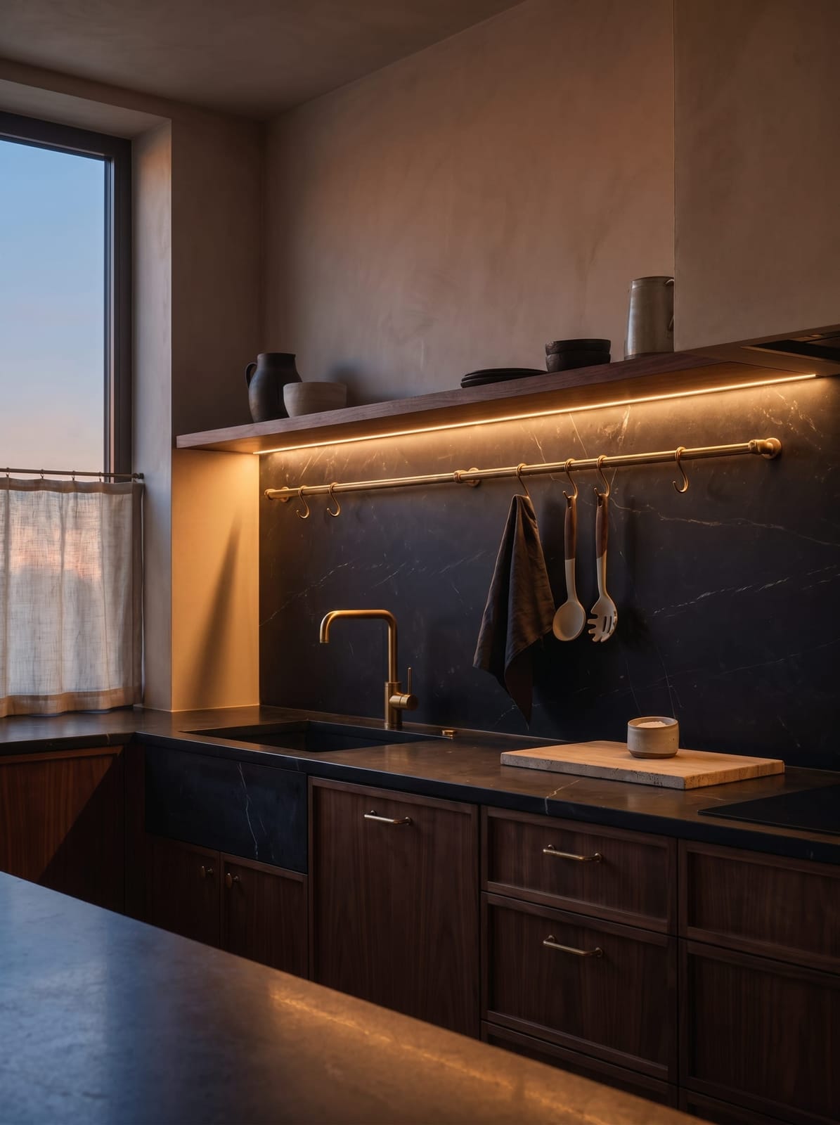 Custom walnut kitchen with dark soapstone countertops, showing a bright sunlit day look and a warm, low-lit evening look.