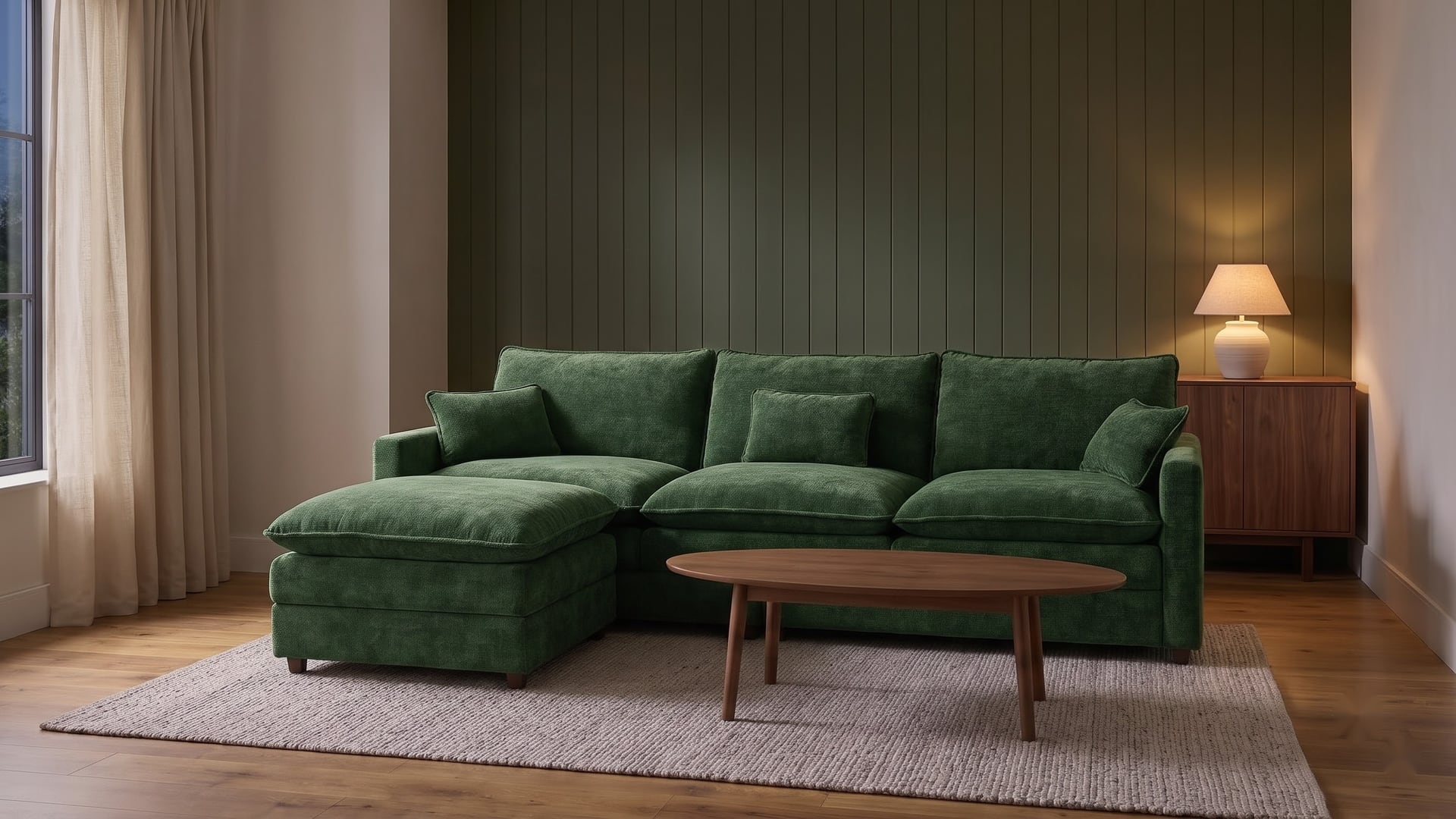 Forest green sectional sofa against deep green panelling with warm lamp light, a walnut coffee table and neutral rug.