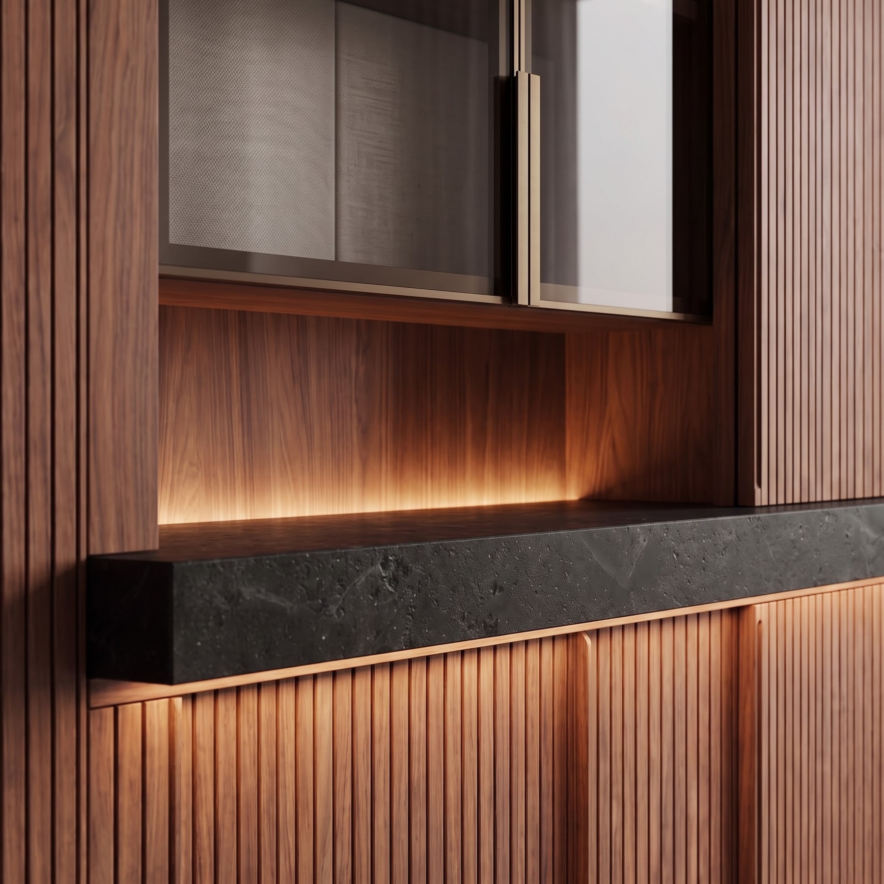 Close-up of slatted walnut cabinetry with integrated cove lighting accentuating a dark stone countertop ledge.