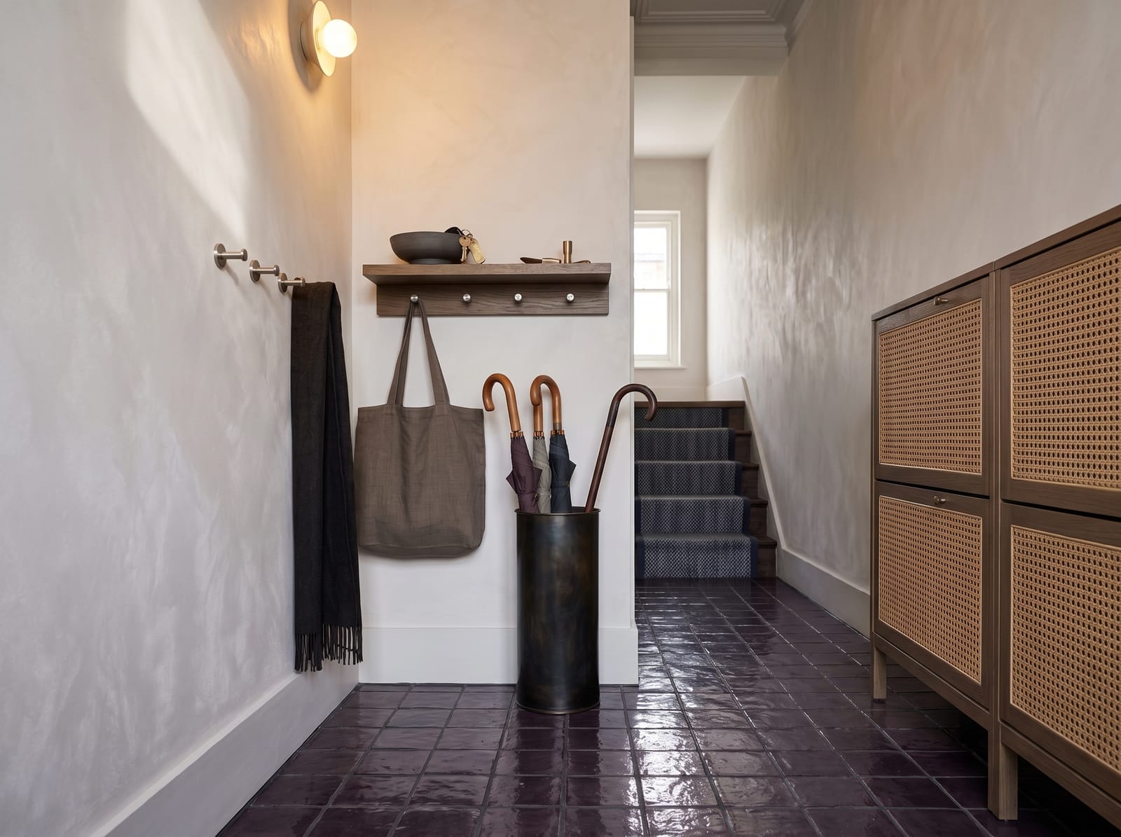 Moody Entry Hallway — warm modern entryway interior concept featuring plaster, oak, copper